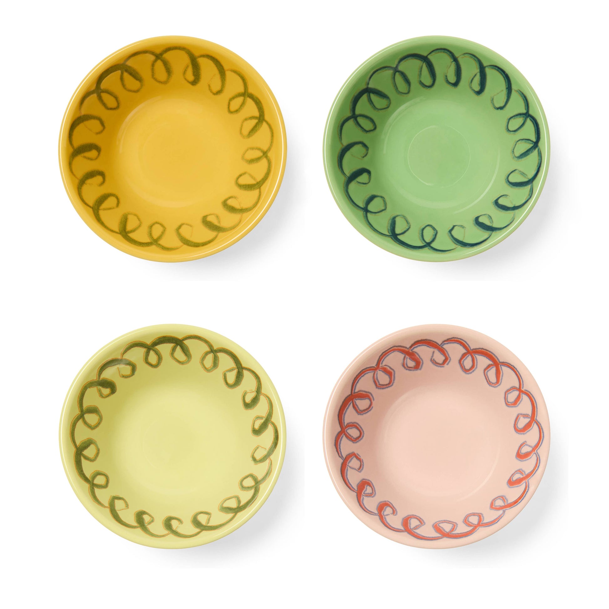 Four ceramic plates with decorative edge designs in yellow, green, pink, and red on a white background.