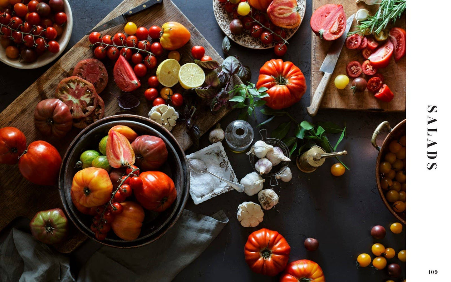 Assorted tomatoes on a wooden table with a focus on fresh produce.