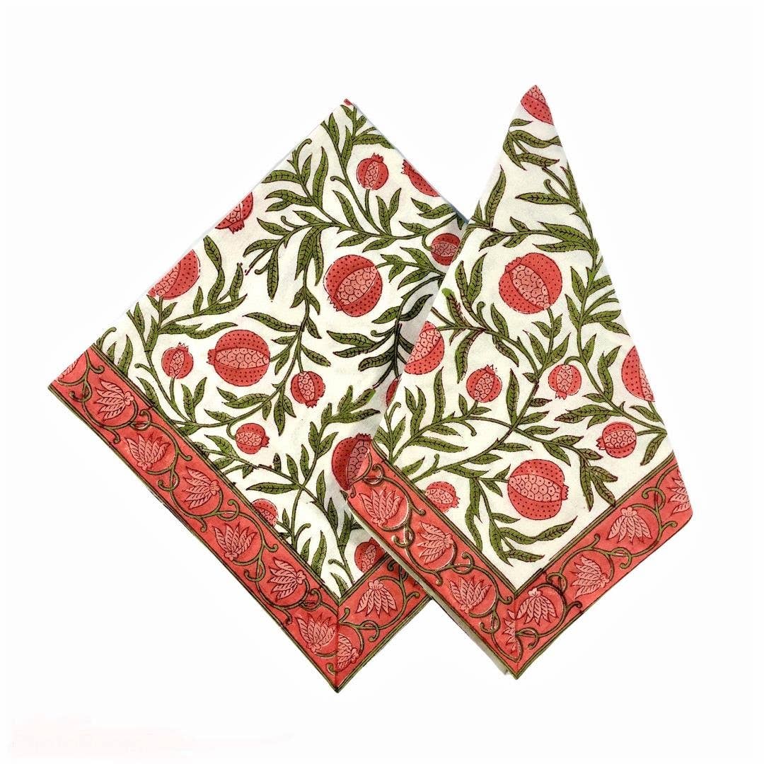 Two patterned napkins with red and green designs on a white background