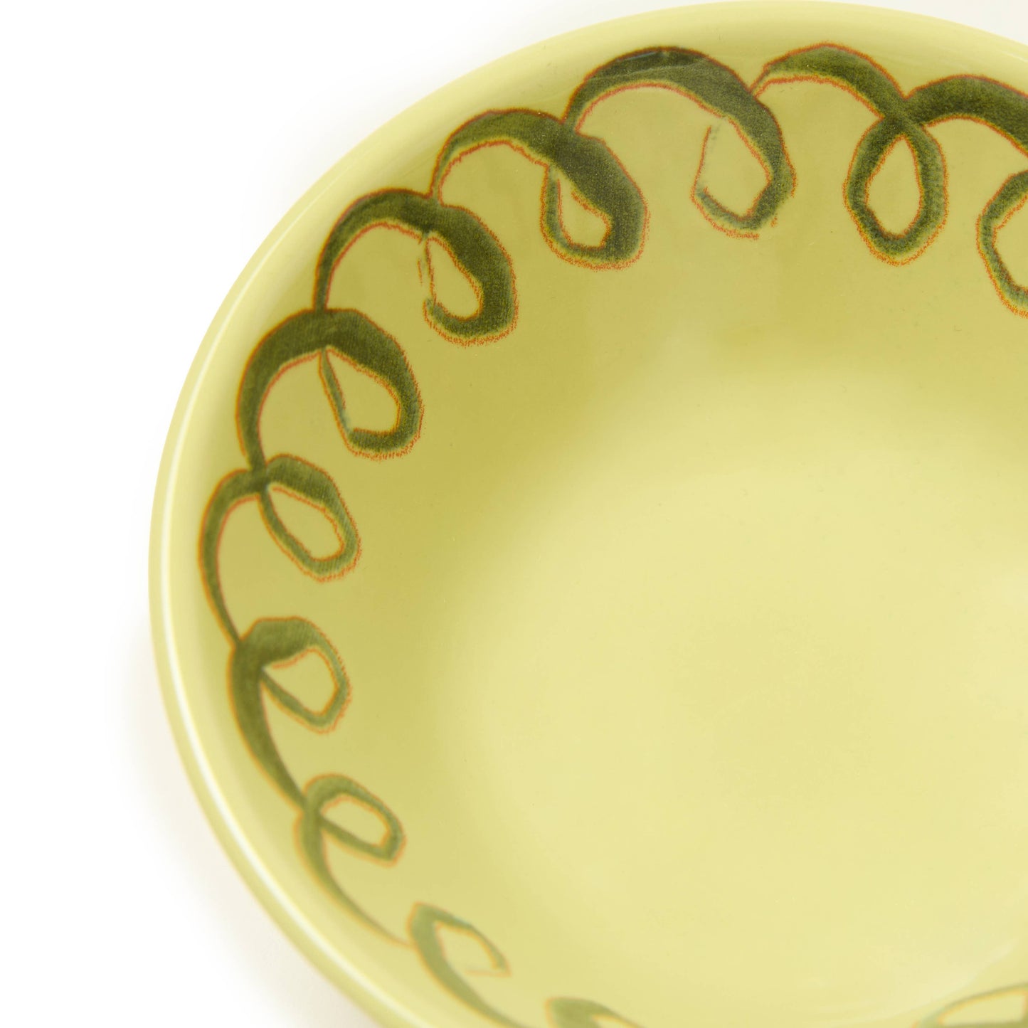 Yellow ceramic plate with green decorative edge on a white background