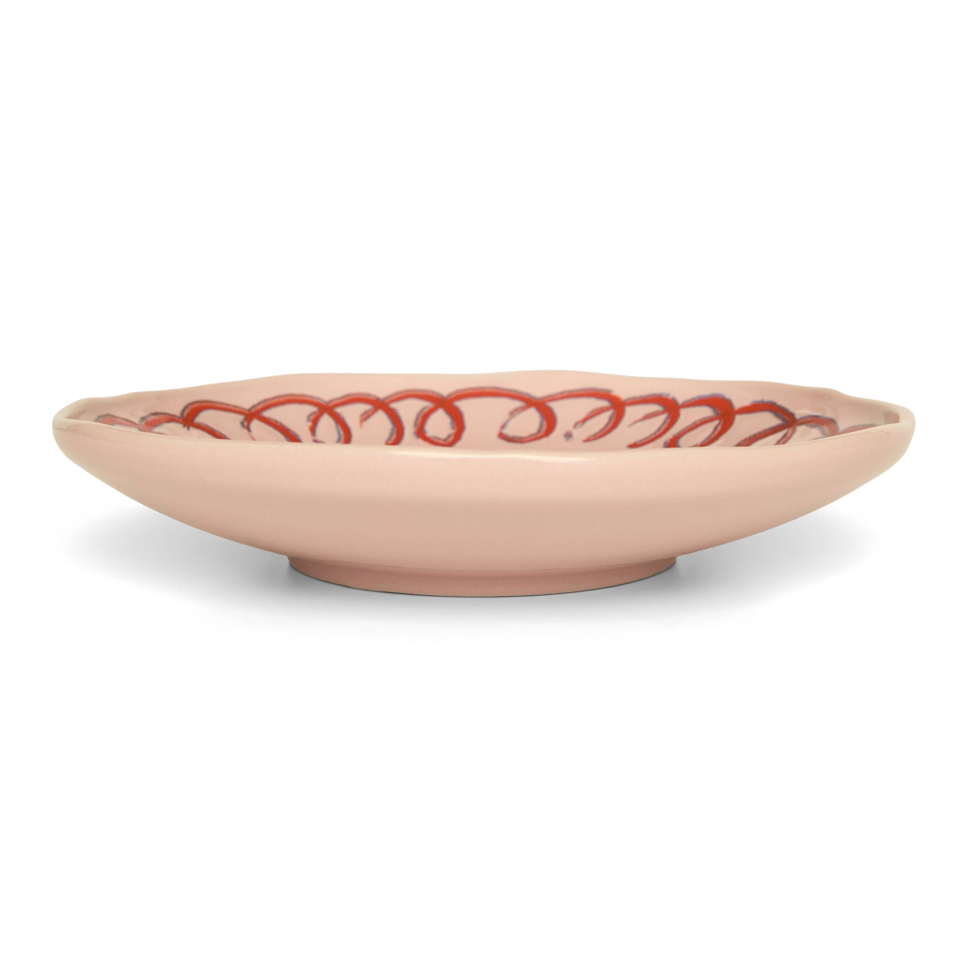 Beige ceramic bowl with red decorative pattern on a white background