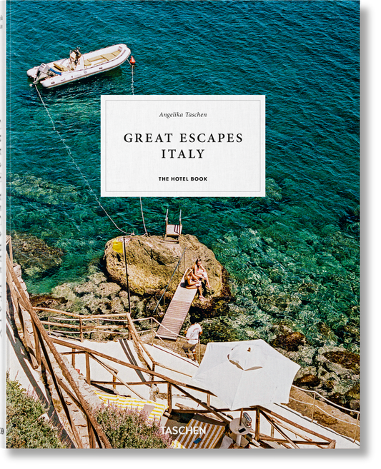 Book titled 'Great Escapes Italy' by Taschen with a scenic view of a boat and cliffside house. Le Marchande