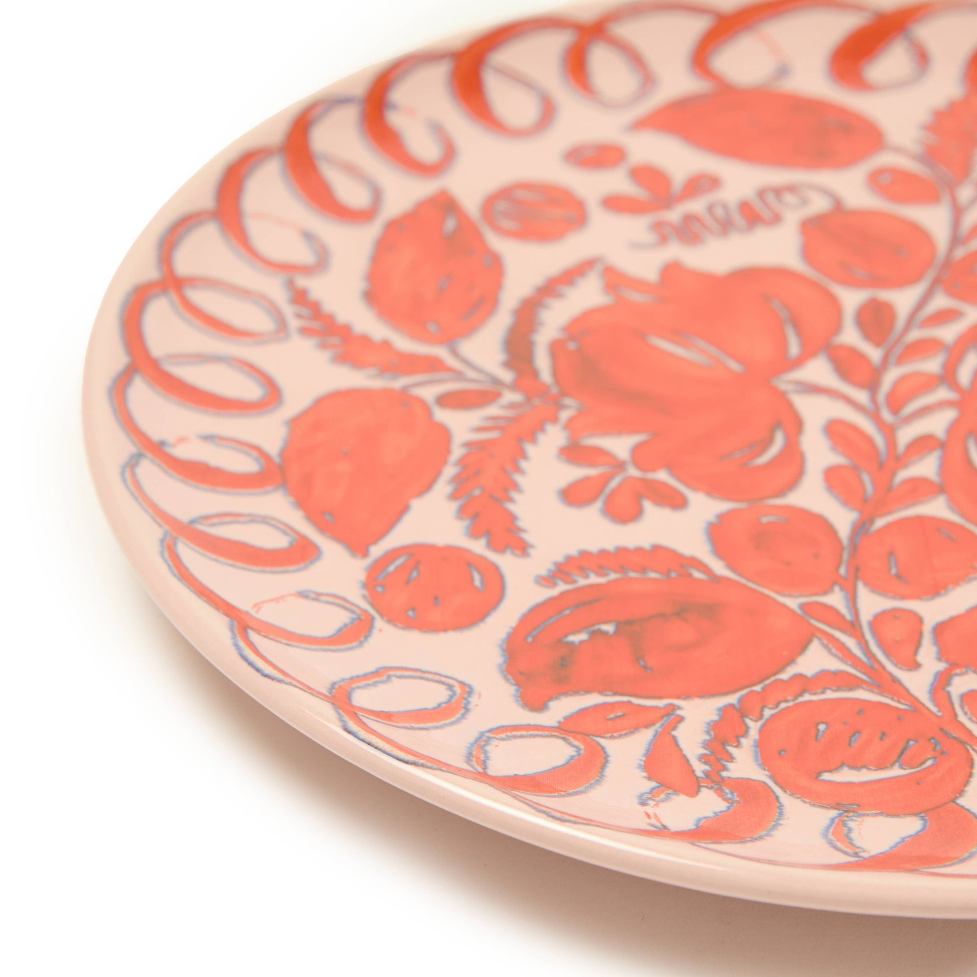 Ceramic plate with red floral pattern on a white background