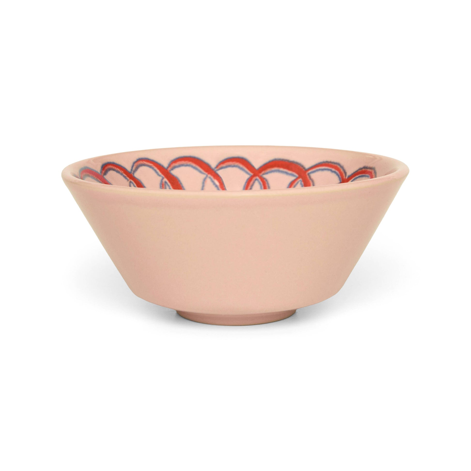 Pink ceramic bowl with red and black pattern on a white background