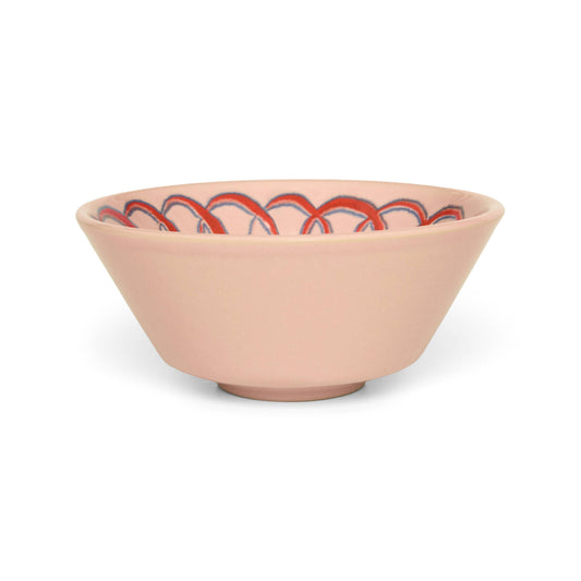 Pink ceramic bowl with red and black pattern on a white background