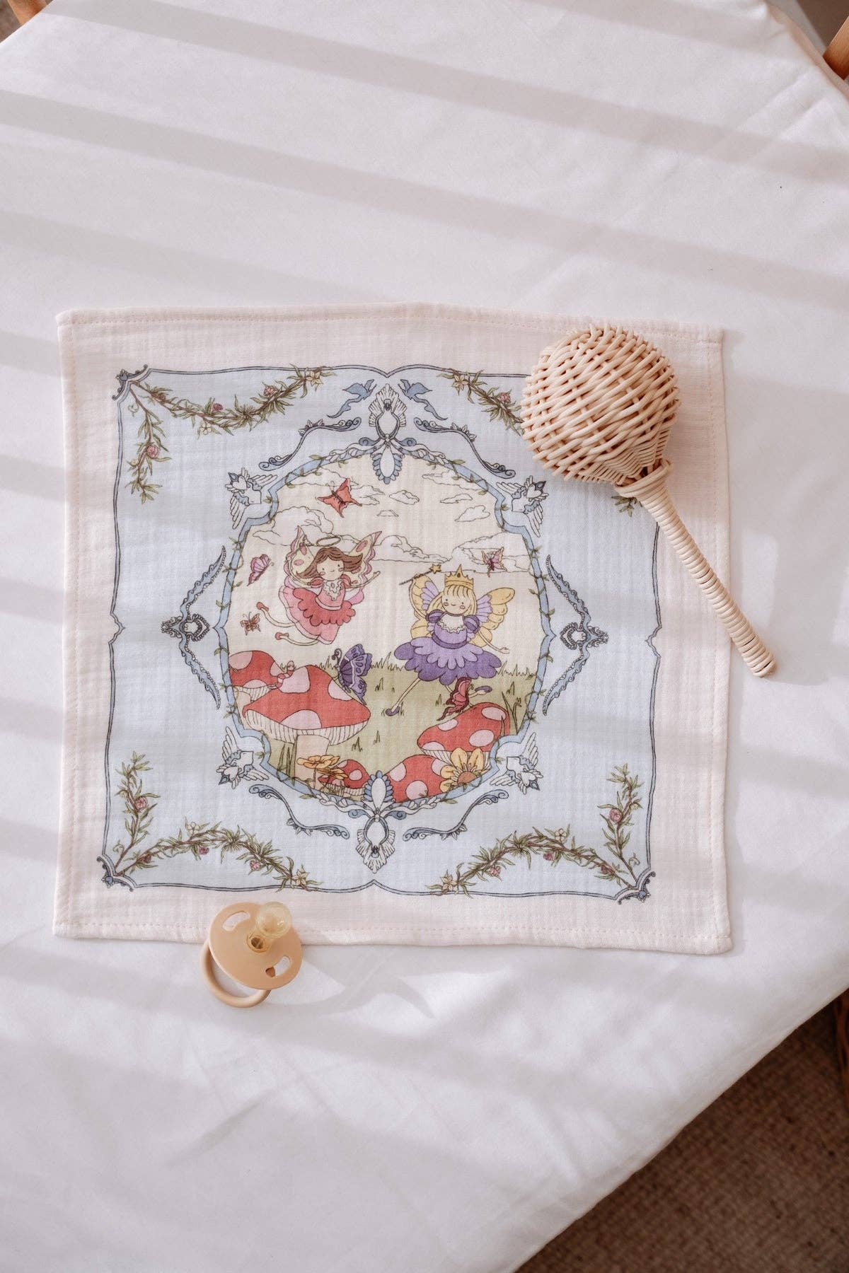 Embroidered fabric with a decorative design on a white surface burp cloth