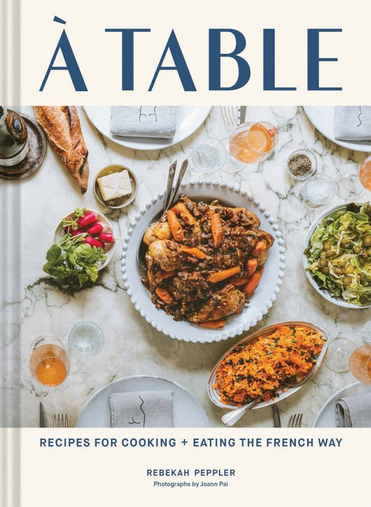 Book cover of 'À Table' with a table setting and food.