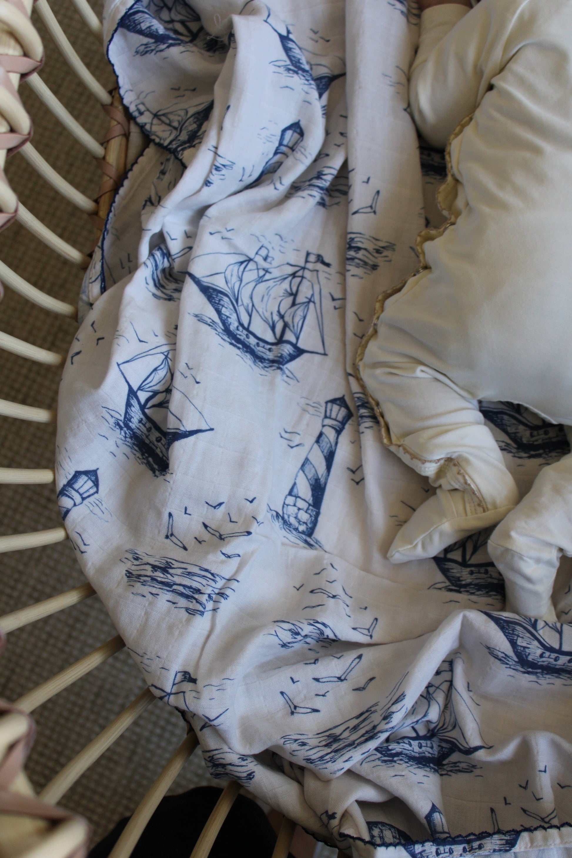 White blanket with blue patterns draped over a chair