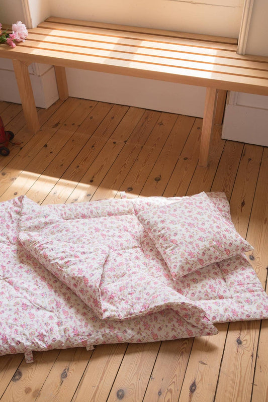 Kids Floral bedding set on a wooden floor with a wooden bench in the background
