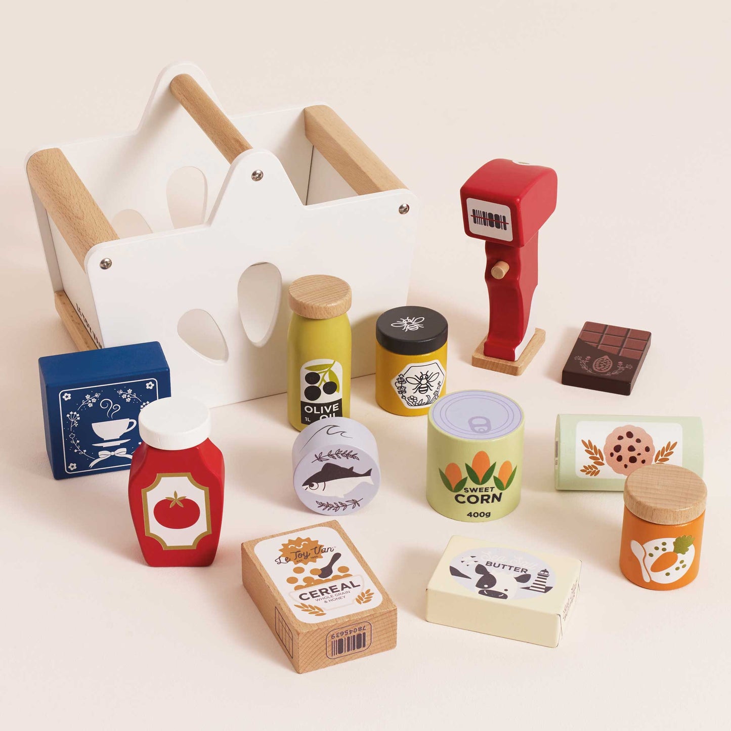 Collection of toy food items and a shopping cart on a light beige background
